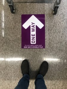 Photo of a grocery store sign directing aisle traffic